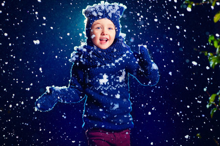 happy kid, boy running under the snow