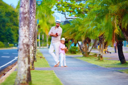 happy father and son, musician playing music on the streetの写真素材