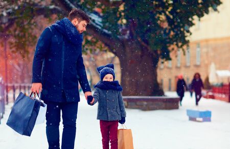 father and son walking on winter shoppingの写真素材