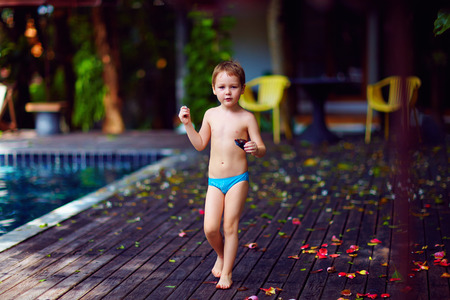 young kid with toy in hands relaxing on exotic vacationの写真素材