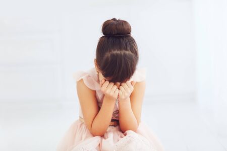 portrait of beautiful young lady hiding her faceの写真素材