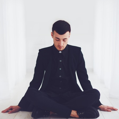 portrait of young handsome man sitting on the floorの写真素材