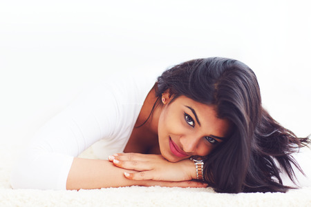 portrait of beautiful young indian woman on carpetの写真素材