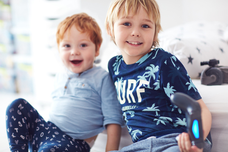 cute happy brothers playing together at homeの写真素材