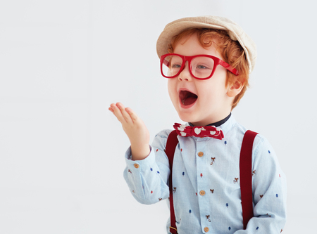 adorable redhead toddler baby boy blowing a kissの写真素材