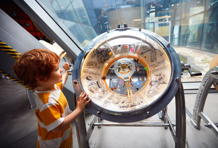 WARSAW, POLAND - June 20, 2019: Kid testing the bacterie universe globe model in the Copernicus Science Centre in Warsaw, Polandのeditorial素材