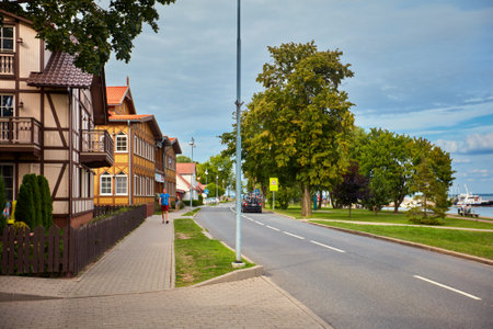 JUODKRANTE, LITHUANIA - August 18, 2019: Beautiful street with old Lithuanian traditional wooden houses. Fishermen's village on Baltic sea, popular tourist destinationのeditorial素材