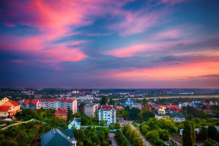 beautiful sunset light have painted the sky and the city down in the valley in pink colours. Uzhhorod, Ukraineの写真素材
