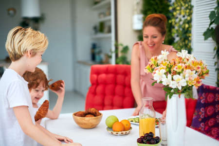 happy family setting laying the table for lunch in the summer garden at homeの写真素材