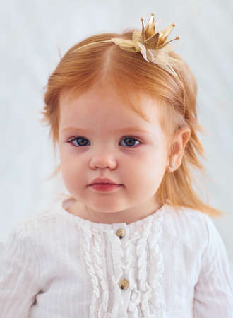 shoulder portrait of a cute nineteen month old baby girlの写真素材