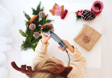 happy kid creates christmas decorations, wraps the presentsの写真素材