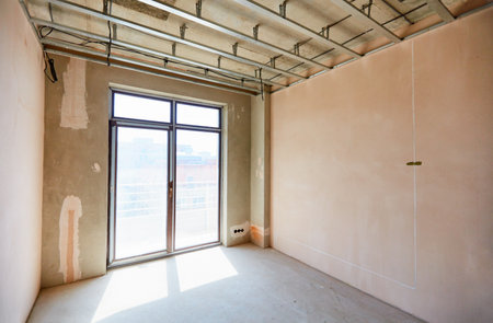 a new apartment repair works in progress, plastering, hanging drywalls and ceiling levelingの写真素材