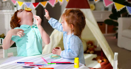 cute siblings, friends playing together at the playroom at home, having fun togetherの写真素材