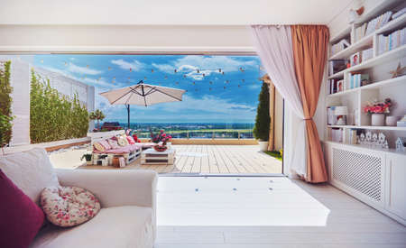 rooftop penthouse apartment with lounge patio zone, sliding doors and open space living roomの写真素材