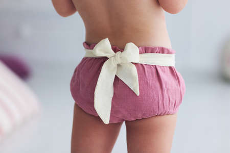 back view of light breathable muslin panties with bow on toddler baby girlの写真素材