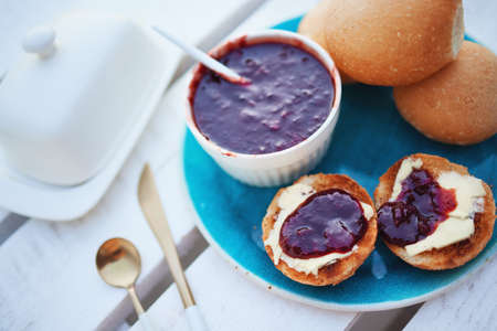 toasted buns with fresh butter and plum jamの写真素材