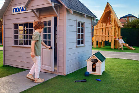 young boy, kid playing games at the miniature city at the playground, outdoor leisure activityの写真素材