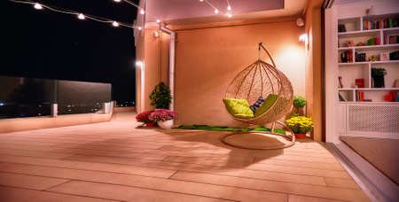 cozy rooftop terrace with open space living room at warm summer nightの写真素材
