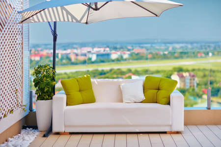 rooftop lounge area on the patio with beautiful view at sunny dayの写真素材