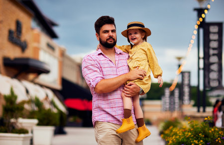 portrait of happy father and baby daughter walking down the streetの写真素材