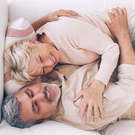portrait of cheerful adult couple relaxing at home. mature romanceの写真素材
