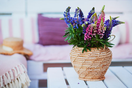 lupine flower bouqet on the wooden pallet furniture at summer patioの写真素材