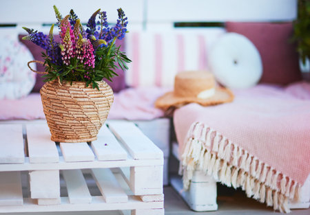 lupine flower bouqet on the wooden pallet furniture at summer patioの写真素材