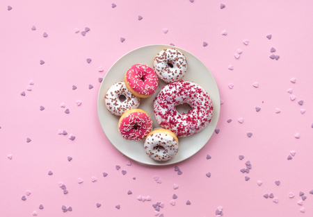 Plant with different donuts on pink background.の写真素材