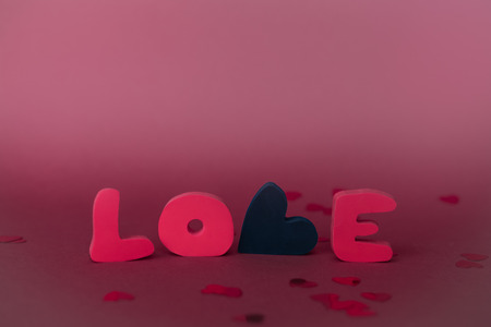 Love composition on pink background. Valentines day greeting card with love word.の写真素材
