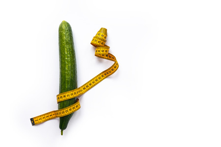 Cucumber with measuring tape isolated on white, copy spaceの写真素材
