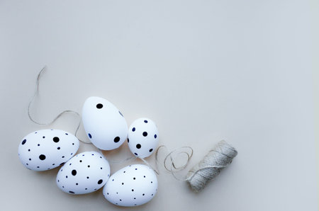 Easter holiday creative background with white Easter eggs on biege table.  Easter concept. Copy...