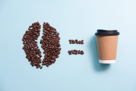 Big coffee bean shape made of coffee beans and paper cup.の写真素材