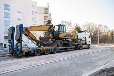 A heavy excavator is transported on a cargo platform