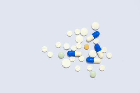 Heap of medical tablets on a white background