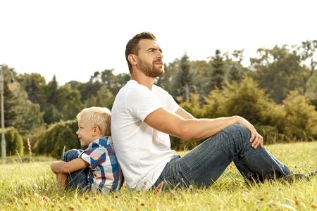 Profile of happy young father and son in the parkの写真素材