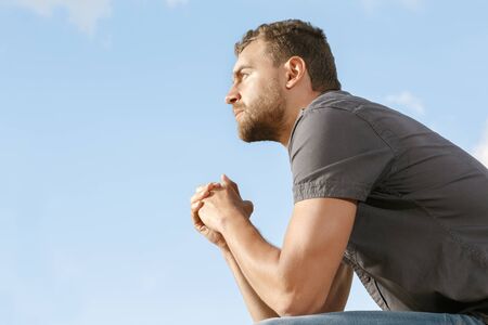 Thoughtful handsome man in a parkの写真素材