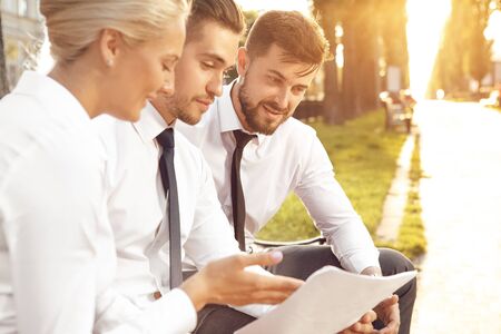 Business partners discussing new project in city parkの写真素材