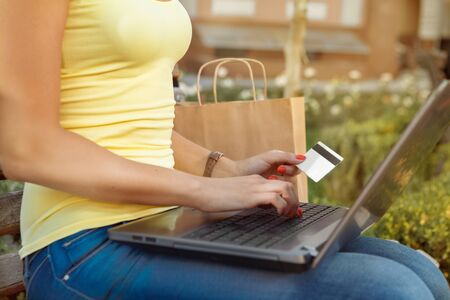 Attractive girl enters into the computer data of her credit cardの写真素材