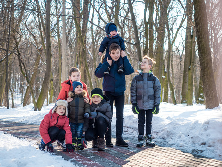 Group of little boys posing for camera in winter parkの写真素材