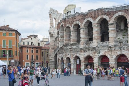 ITALY, VERONA - JULY 13, 2014: Piazza Bra with many tourists and a fragment of the Arena of Verona.のeditorial素材
