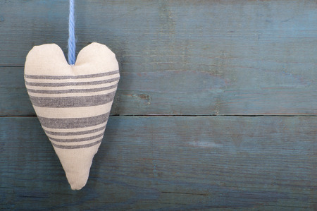 Textile heart on the background of the old wooden walls.の写真素材