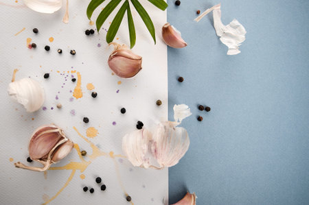 Garlic cloves on a beautiful watercolor background of white and blue.の写真素材