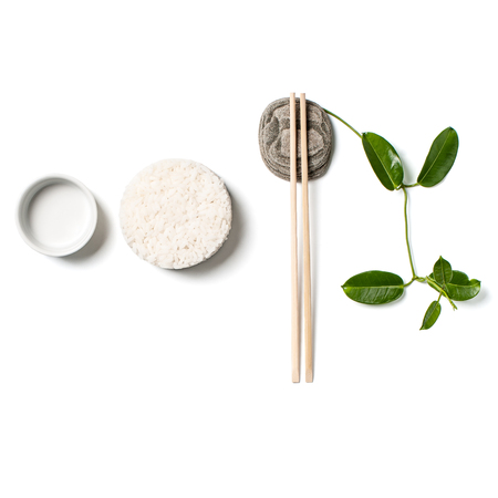 Composition with white rice and chopsticks on white background.の写真素材