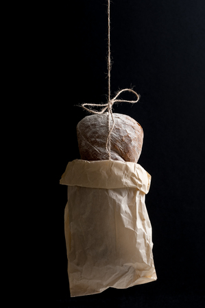 Fresh bread in a paper bag on a black background.
の写真素材