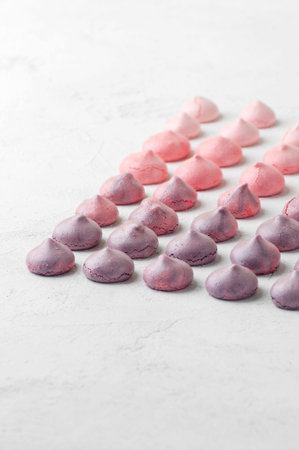 Strawberry and blueberry meringues in purple-pink colors