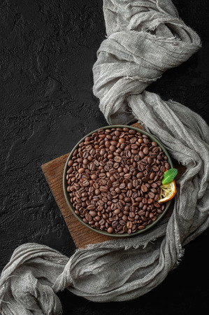 Freshly roasted coffee beans on a dark table. Low key photography flat-lay.の写真素材