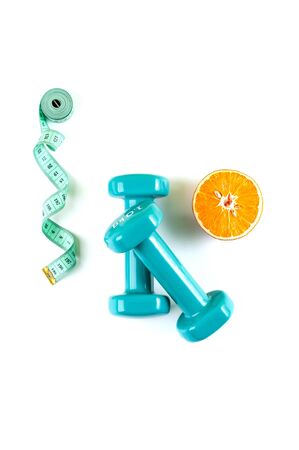 Dumbbells, a centimeter and half an orange on a pure white background.
の写真素材