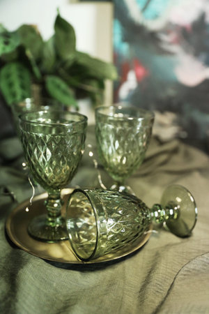 Green glasses on the table with a green cotton tableclothの写真素材
