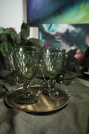 Green glasses on the table with a green cotton tableclothの写真素材