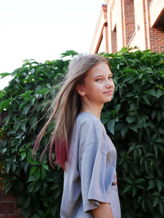 teen girl on the green leaves greenery